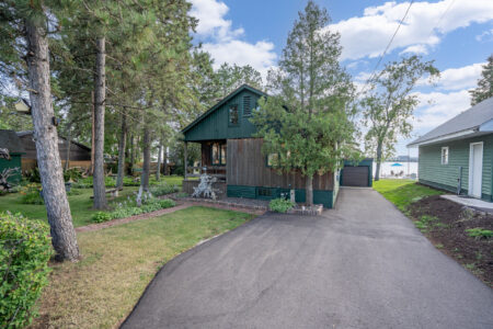 Bayview Cottage exterior showing spacious yard and mature trees